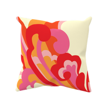 bright red, orange, and pink swirls from Fibbage 3 on a cream pillow