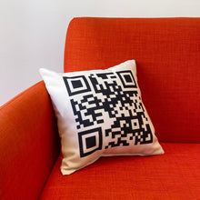 Fibbage 3 pillow with QR code on an orange chair